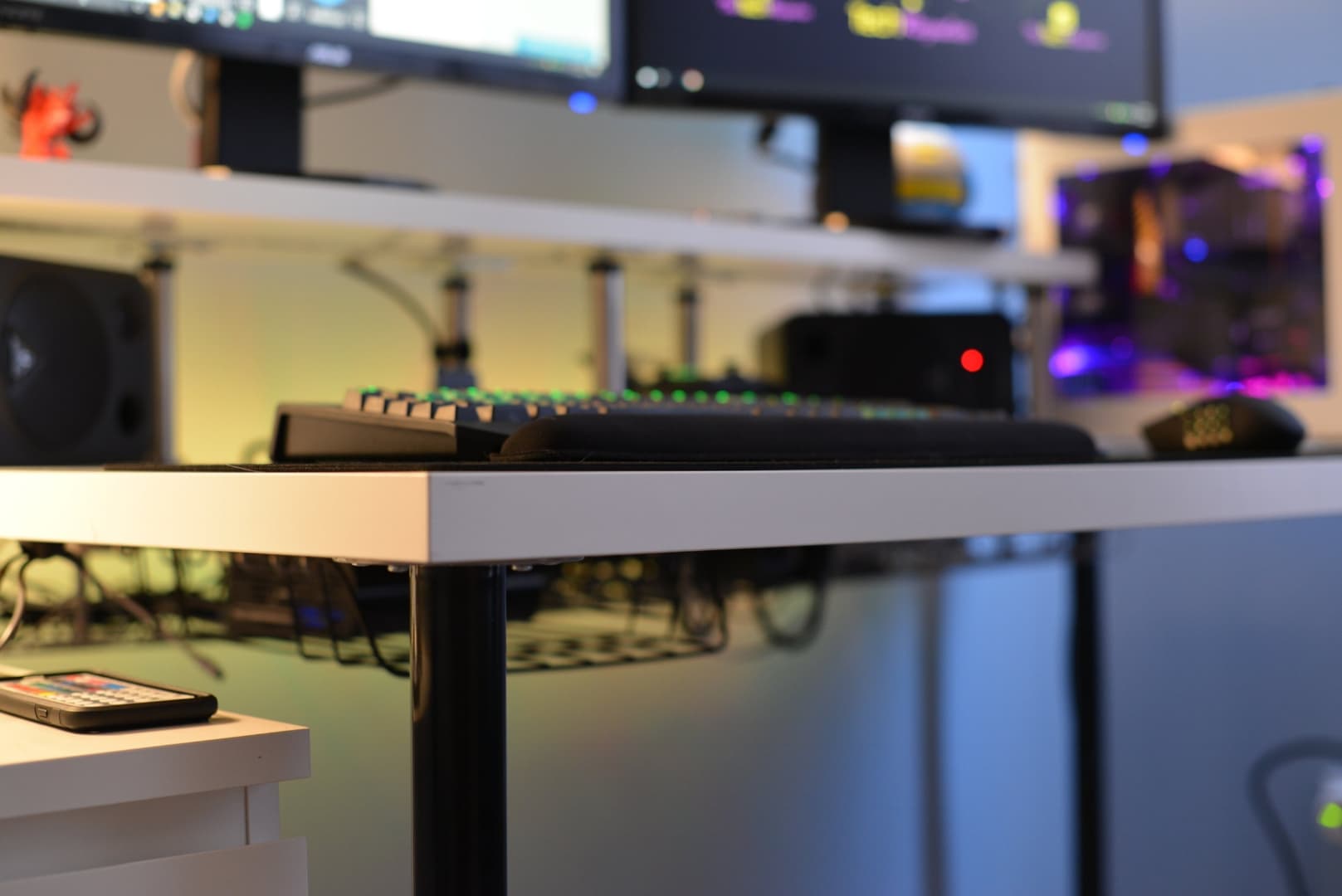 A desk with a computer, monitors, keyboard, and mouse