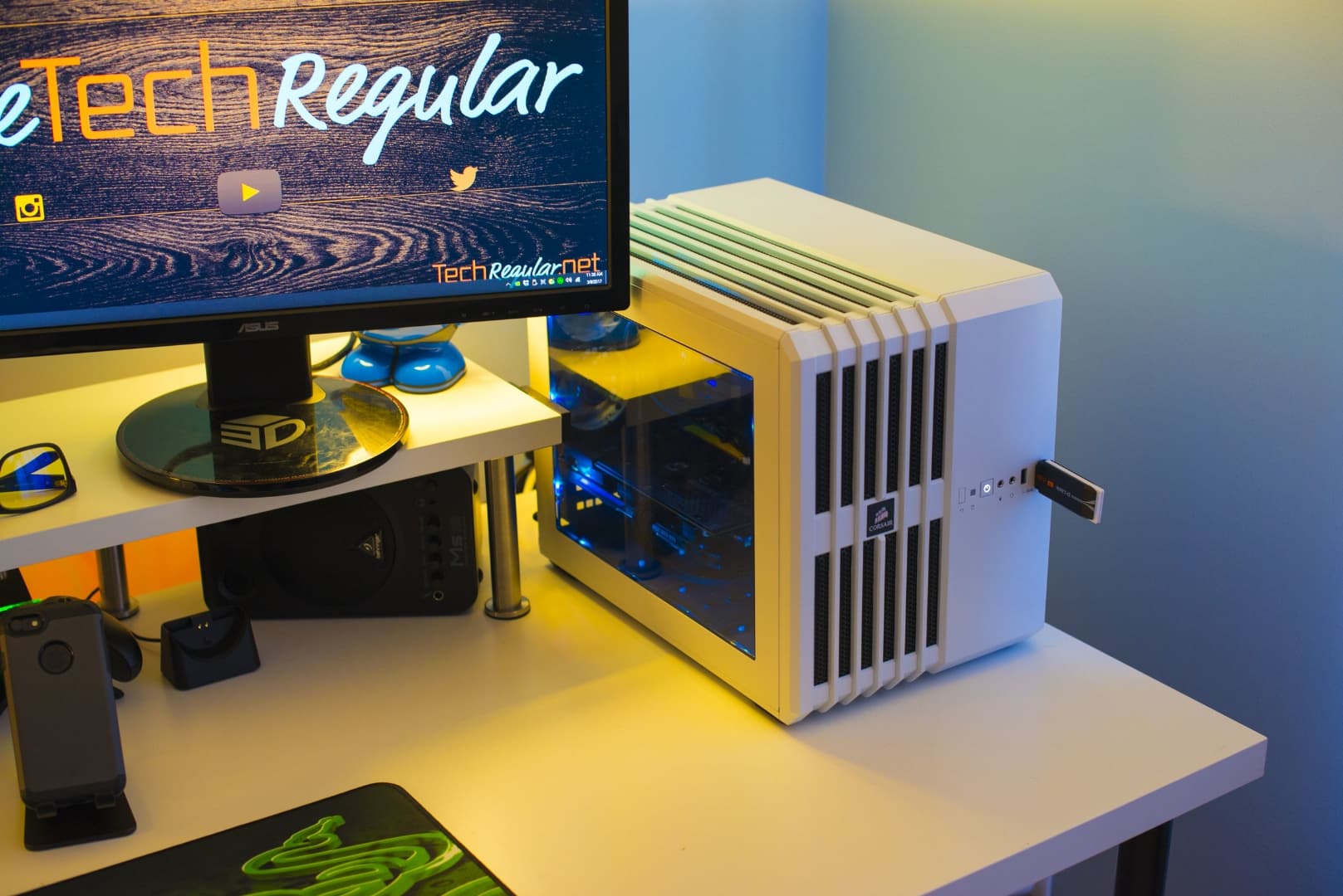 Desk with computer as main focus with a monitor