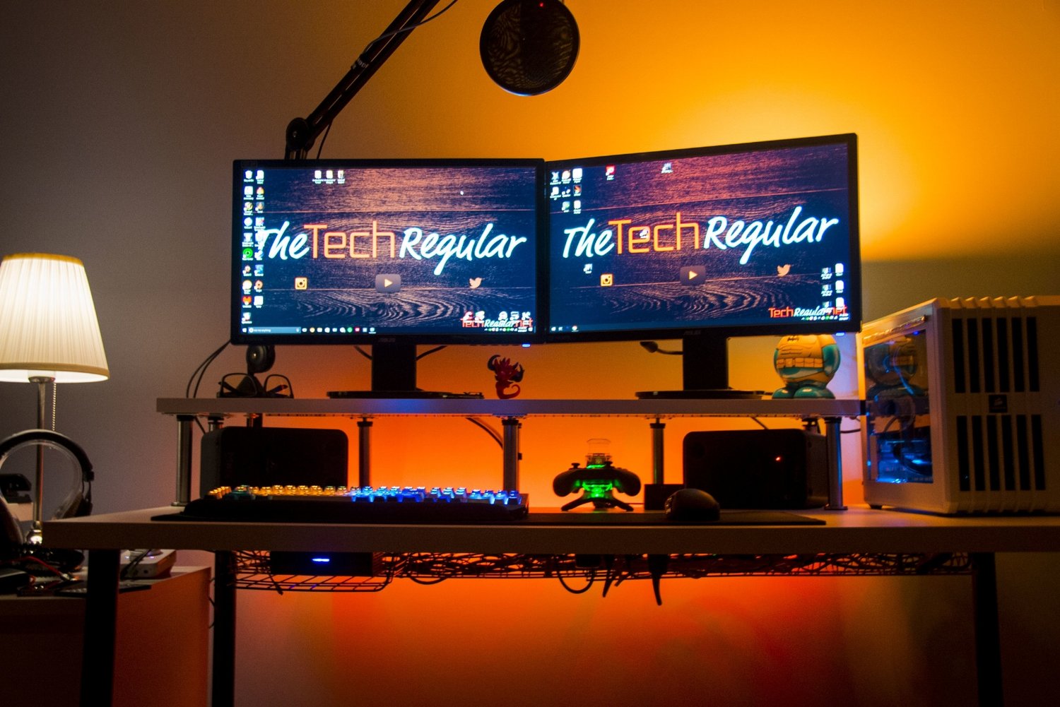 Desk with monitors and computer. Also within view is an under mounted cable tray with well managed cables